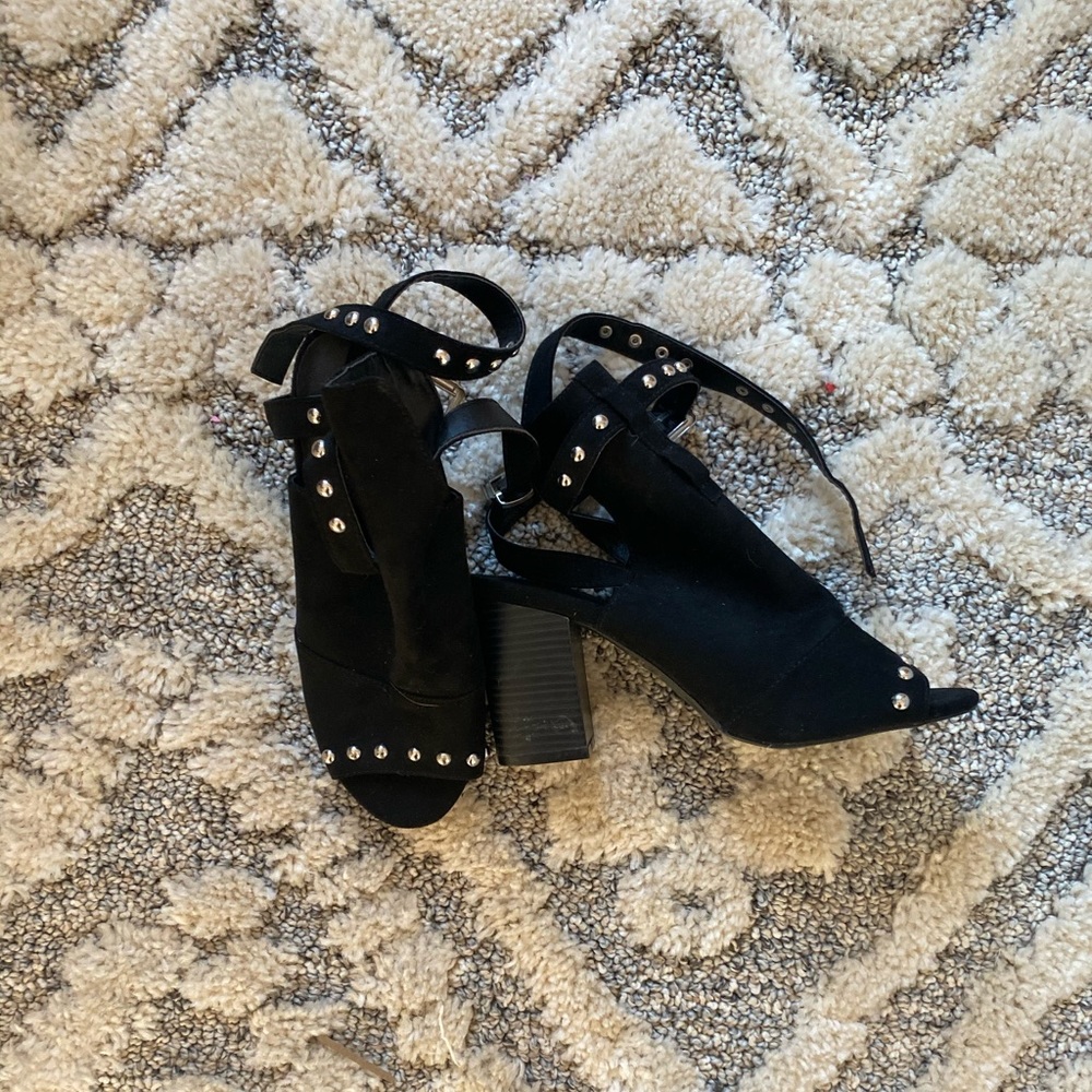 Black heeled open toe booties.